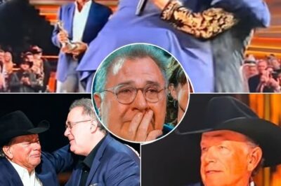 CMA AWARDS 2025 DESCEND INTO CHAOS AS GEORGE STRAIT SHOCKS EVERYONE WITH UNANNOUNCED, TEAR-JERKING APPEARANCE FROM DARKNESS TO HONOR VINCE GILL — A HEART-STOPPING, EMOTIONAL EXPLOSION THAT LEFT THE ENTIRE ARENA BREATHLESS AND SOBBING LIVE ON STAGE! No word, no hint, no warning. The 59th CMA Awards held its breath as Vince Gill stood moments away from receiving the Willie Nelson Lifetime Achievement Award—when suddenly, the stage lights flickered out, plunging Bridgestone Arena into complete darkness. From the blackness, a solitary figure emerged—wide-brimmed hat low, slow, deliberate steps that sent shockwaves through the stunned crowd. For two agonizing seconds, silence reigned—then the arena erupted in a roar of disbelief and awe as the “King of Country,” George Strait, revealed himself. There were no introductions. No fanfare. Just the raw, electric power of a friendship decades in the making. Cameras caught every tear, every tremble, as George reached Vince, gently placed a hand on his shoulder, and uttered words that stopped time itself: “No one deserves Willie more than you… and to say that, I had to come here myself.” Vince’s eyes welled instantly. His voice cracked as he whispered back, “George… I’m speechless. Thank you.” The arena was swallowed by a wave of emotion—tears flowed freely, breaths caught in throats, hearts united in a moment of pure, unfiltered love and respect. This was more than an award presentation—it was a soul-stirring testament to legacy, brotherhood, and the power of music to heal. WATCH THE UNFORGETTABLE VIDEO BELOW 👇