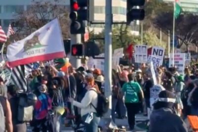 Protesters Against ICE & Donald Tru::mp Gather Outside Super Bowl LX [VIDEO]